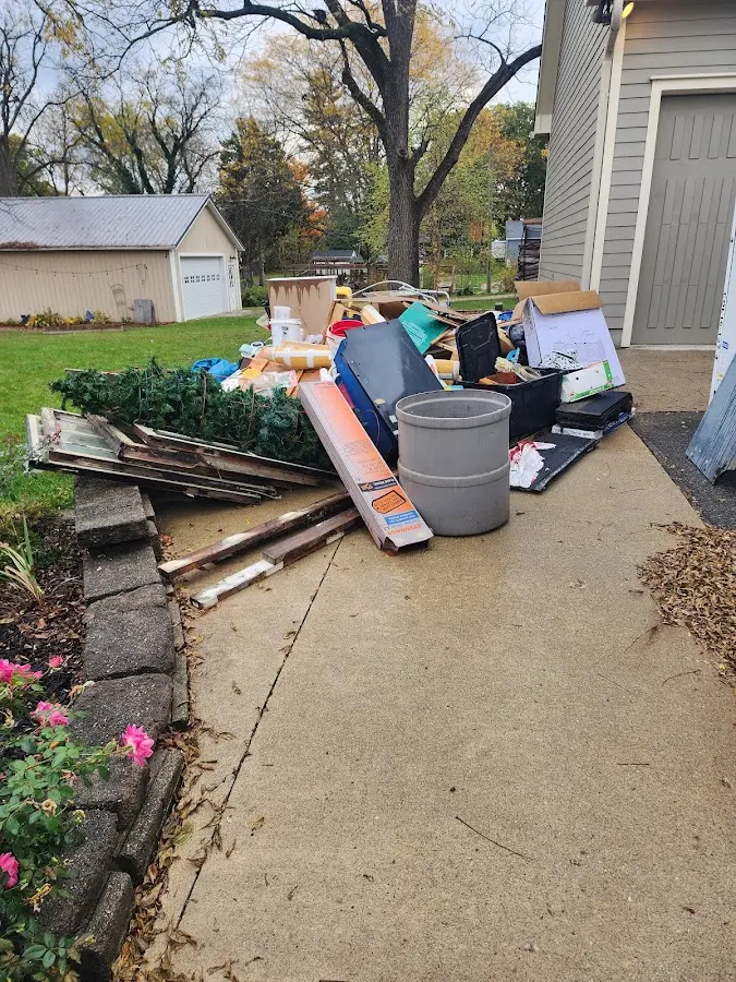 Dumpster being loaded with debris for Estate Cleanout Dumpster Rental in Mariemont